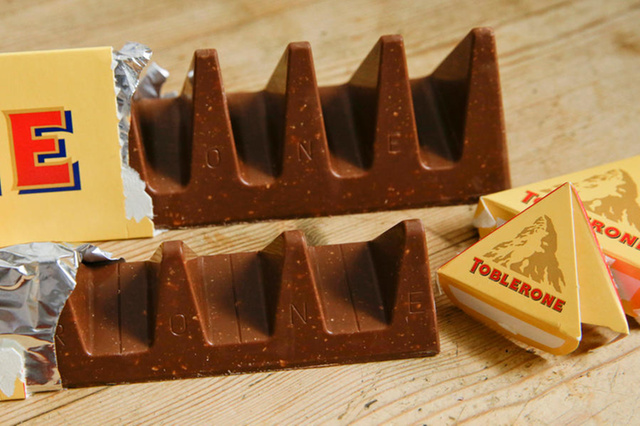 In this photo illustration two bars of the Toblerone Swiss chocolate are shown, at front is the new style 150 gram bar showing the reduction in triangular pieces, in the background is the older style 360 gram bar, pictured in London, Tuesday, Nov. 8, 2016. More valleys, fewer chocolate peaks: The maker of Toblerone Swiss chocolate says it's widened the spaces in its iconic, triangle-array bars for some discount shops in Britain to keep prices down. Mondelez International says the move aims to meet pricing targets by customer Poundland and other discount retailers, and has nothing to do with Britain's vote to leave the European Union. (AP Photo/Alastair Grant)